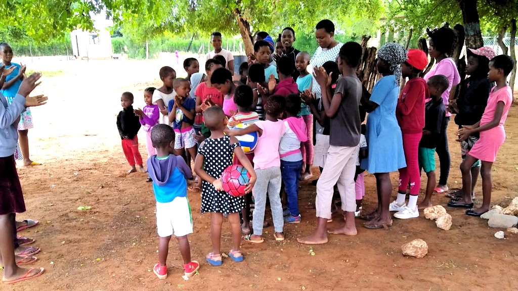 Children's ministry under the trees in Dimajwe
