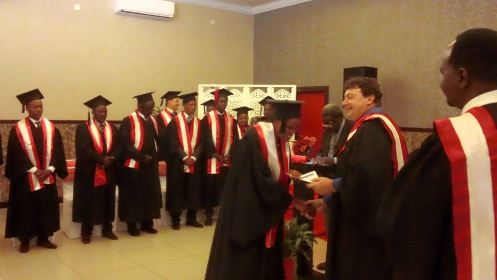 Students receiving diplomas at graduation